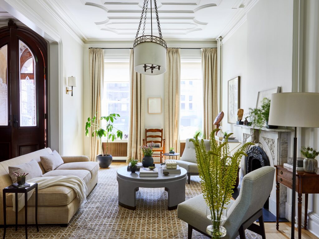 Elegant living room with chairs and a sofa arranged around a central coffee table to create a welcoming conversation area.