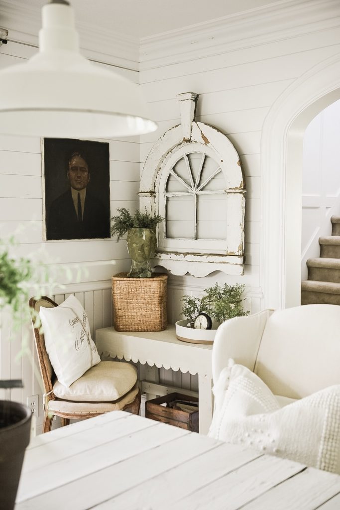 Cozy winter corner with neutral furniture, vintage accents, and soft textures creating a calm anchor space for a gentle winter home reset.
