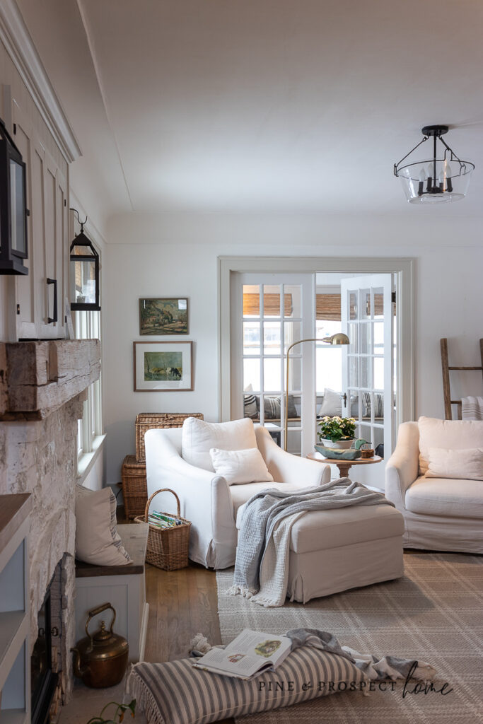 Cozy winter seating area with fireplace, soft neutral furniture, and layered textures styled for a gentle winter home refresh.