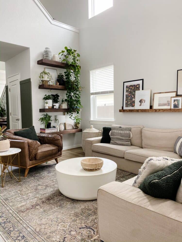 Open-concept living room with neutral furniture, soft textures, and greenery, designed to feel warm and balanced during winter.